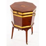 A George III mahogany and brass bound cellarette of octagonal shape,