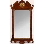 A George III walnut fret framed mirror with gilt shell to crest,