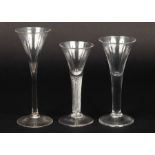 Three 18th Century wine glasses of drawn trumpet form, one with air twist stem,