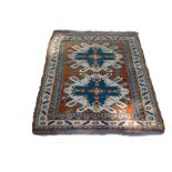 A Hamadan rug with two geometric medallions to the orange ground within a figured border,