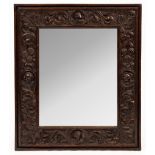 A 19th Century carved oak mirror,