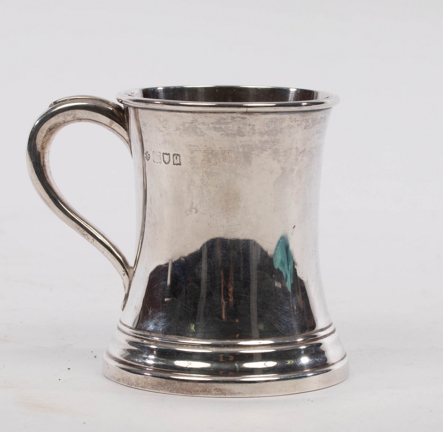 A silver Christening mug, London 1911, of plain waisted form, 9cm high,