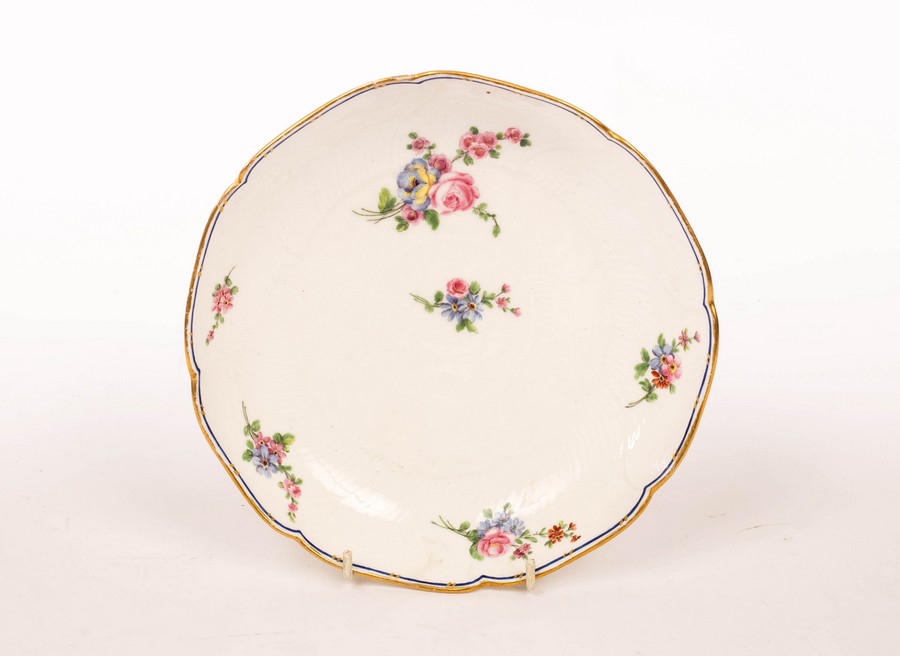 A Sèvres circular dish, date letter t for 1772, moulded with overlapping concentric leaves,