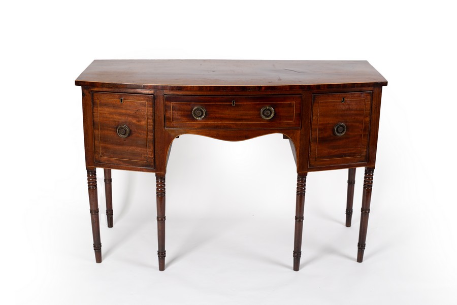 A George III mahogany bowfront sideboard on turned legs,