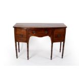 A George III mahogany bowfront sideboard on turned legs,