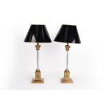 A pair of table lamps with clear fluted columns on gilt metal stepped bases with black japanned