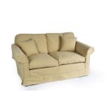A square framed sofa fitted loose cushions on turned legs,