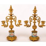 A pair of French two branch three-light table candelabra, on Sèvres style plinths, 31.