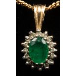 An emerald and diamond cluster pendant on a fine 9ct gold neck chain, gross weight approximately 4.