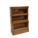 A Globe Wernicke type oak bookcase, the three sections with rising glass panel doors, 86.