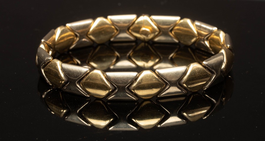 An 18ct bi-colour gold bracelet, of alternating diamond and hourglass links, 20cm long,