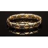 An 18ct bi-colour gold bracelet, of alternating diamond and hourglass links, 20cm long,