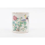 A Chinese tankard painted an exotic bird in flowering branches,