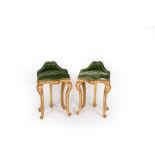 A pair of harpist type stools with buttoned seats and shallow backs on four cabriole legs,