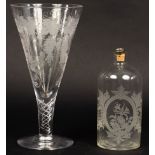A large glass etched with grapes and vines on an air twist stem,
