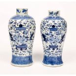 A pair of 19th Century Chinese vases decorated boys supporting a vase, four character marks, 26.
