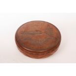 A Japanese carved hardwood circular box, decorated buildings in landscapes,