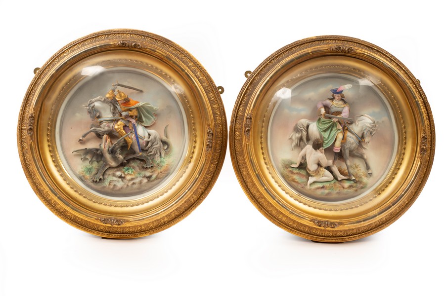 A pair of late 19th Century Continental ceramic plaques, one depicting St George and the Dragon,