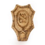 An alabaster panel of cartouche shape with central armorial above a feather motif,