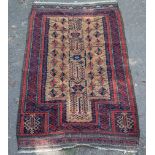 A Baluch prayer rug with central geometric field on a brown ground,