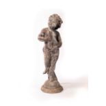 A lead figure of a boy with a fish,