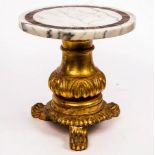 A low marble top table on carved and gilded base with three feet,