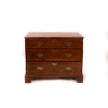 A late 18th Century walnut chest of three long drawers on bracket feet,