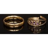 A 9ct yellow gold bangle set with three oval amethysts, approximately 11.