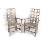 A pair of yew wood garden armchairs with slatted backs and solid seats on square legs