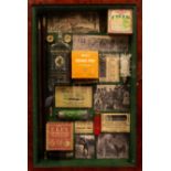 A wall hanging display case containing shooting ephemera to include cartridge boxes,