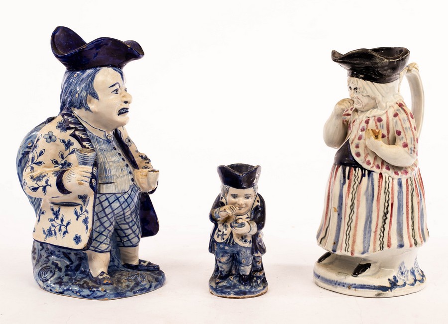 A Delft figural Toby jug of a toper, 28cm high, a Staffordshire female Toby jug of a snuff taker,