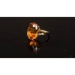 A citrine cocktail ring, the oval stone in an 18ct gold setting,
