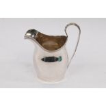 An Edwardian silver cream jug, Nathan & Hayes, Chester 1908, with reeded lip and loop handle,