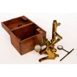 A small gilt brass microscope in fitted wooden case and several volumes on the microscope including