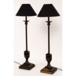 A pair of lamps with stepped bases and vase shaped supports to a slender column,