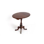 A Victorian mahogany oval table on a turned column and quadruple support,