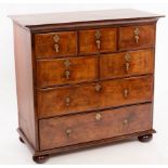 An early 18th century walnut and feather banded chest of three short over three long drawers,