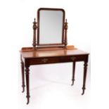 A Victorian mahogany dressing table with swing mirror, on turned legs,