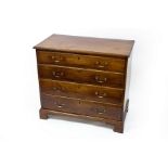 A George III mahogany chest of four long graduated drawers on bracket feet,