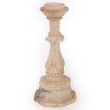 An alabaster column with quadruple dolphin supports on an octagonal base,