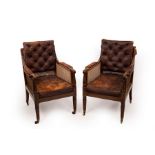 A pair of William IV mahogany library bergère armchairs on front turned tapering reeded legs and