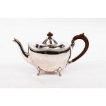 A silver teapot, Birmingham 1941, of oval form with wavy rim on four scroll feet,