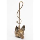 A brass door porter modelled as a fox mask with loop handle,