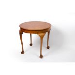 An 18th Century style circular table on cabriole legs with ball and claw feet, 83.