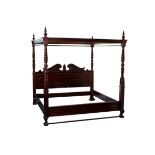 A reproduction four-poster bed with broken swan neck headboard,