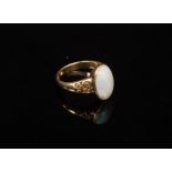 An opal set dress ring, the oval stone in an 18ct yellow gold setting with scroll shoulders,