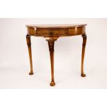 A Queen Anne style D-shaped walnut table, fitted a drawer and on cabriole legs with pad feet,