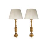 A pair of Gothic style gilt metal table lamps,