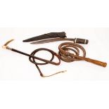 A riding crop with a silver mounted horn handle,