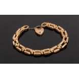 A 9ct yellow gold bar link bracelet, with heart shaped padlock clasp, approximately 20.
